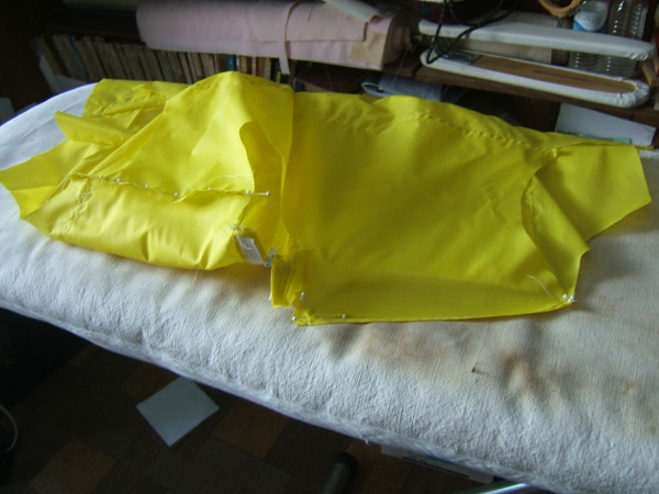 shirt on ironing board, pinning second 
                     shoulder