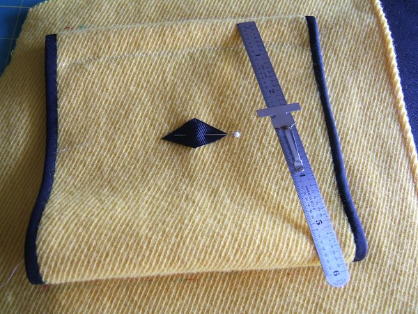 steel ruler near ribbon pinned to pocket