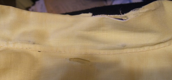 hole in yoke of yellow linen jersey