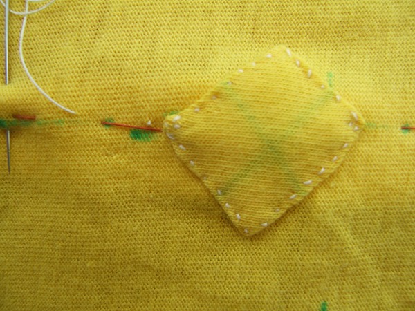 closeup of sewn patch and needle