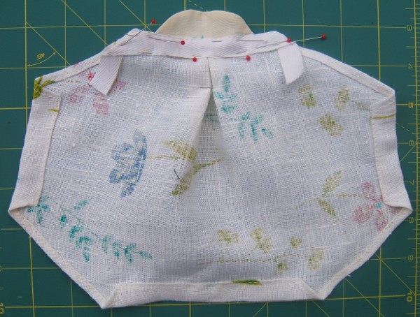 facing sewn to mask, pinned to back