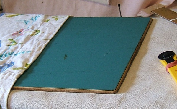 cutting mat and board ready to shorten cotton-lined gown