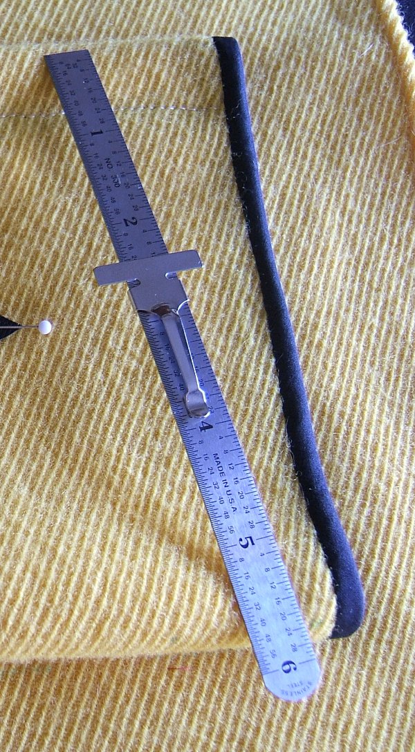 steel ruler on front pocket of overjersey