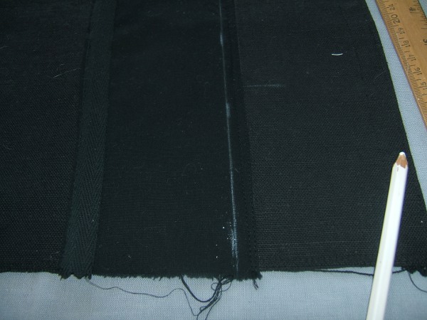 card-pocket strip sewn to main piece, with final-stitching line 
                     marked