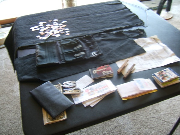 table with wallet, contents, and fabric